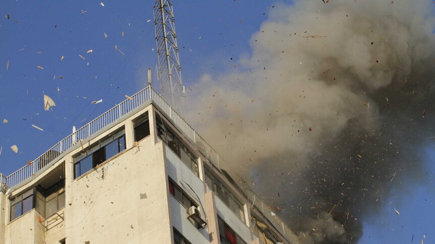 Smoke rises after an Israeli air strike on an office of Hamas television channel Al-Aqsa in Gaza City on November 18.