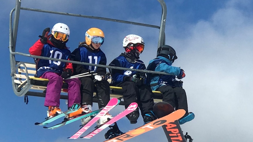 skiiers on a chairlift