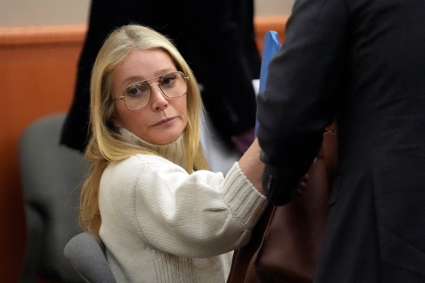 Gwyneth Paltrow in a sumptuous cream knit jumper and oversized 70s style glasses