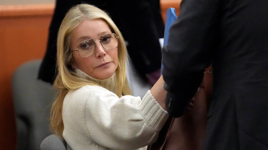 Gwyneth Paltrow in a sumptuous cream knit jumper and oversized 70s style glasses