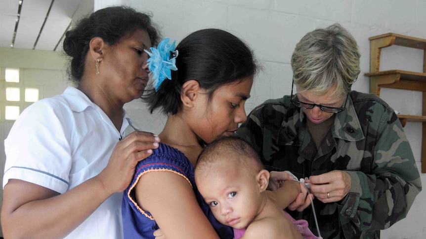 Kiribati infant being treated