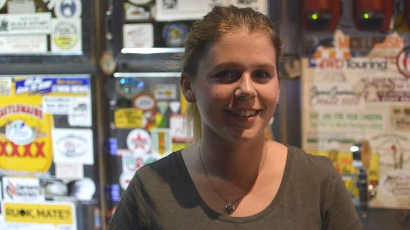 Backpacker Bethan Davies standing behind the bar at Windorah's only pub.
