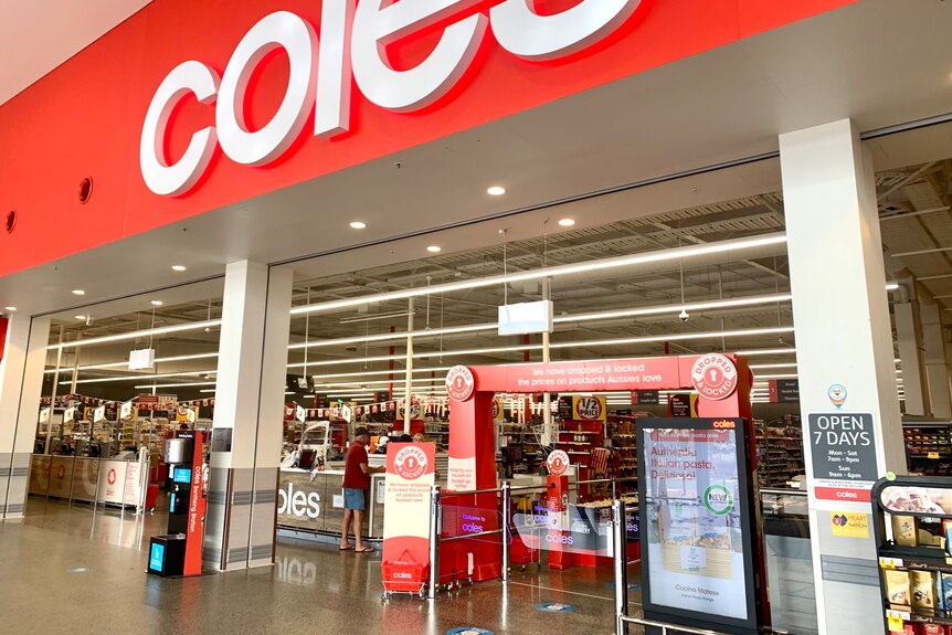 A Coles shopfront with staff and customers