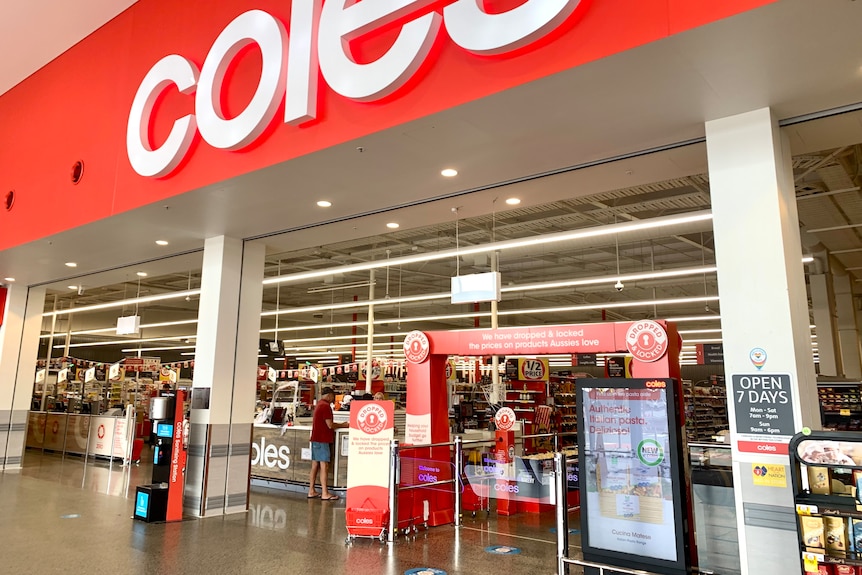 A Coles shopfront with staff and customers