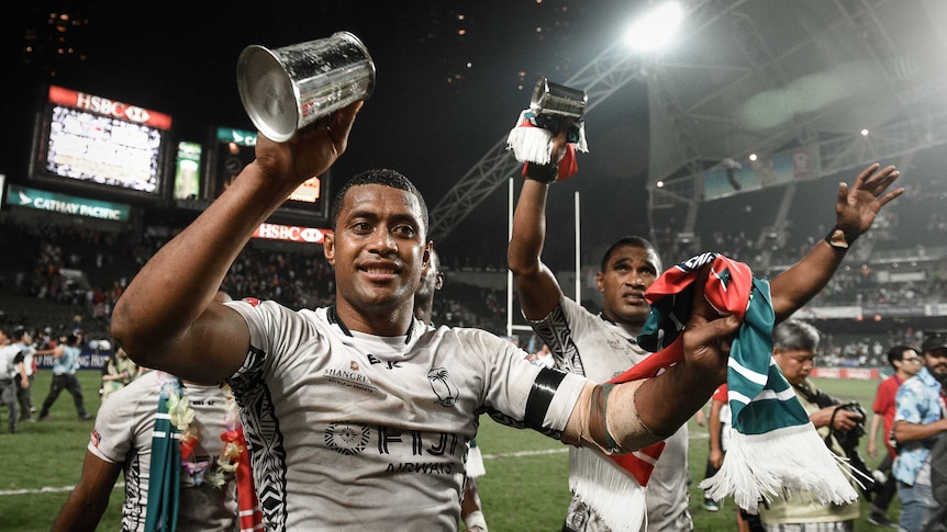 Fijian players celebrate after beating New Zealand in the 2015 Hong Kong Sevens Cup final.