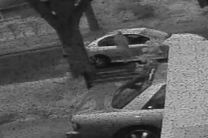 A car pulls up alongside two women.