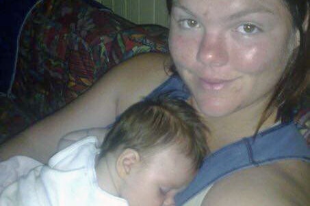 Carleon Russell with her baby Verity asleep on her chest.