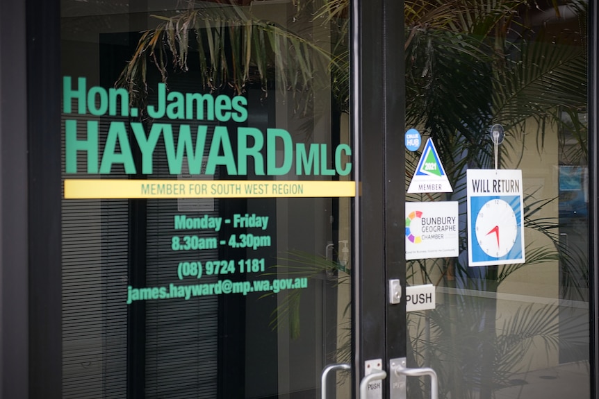 Branding material printed on the front of a glass door and window