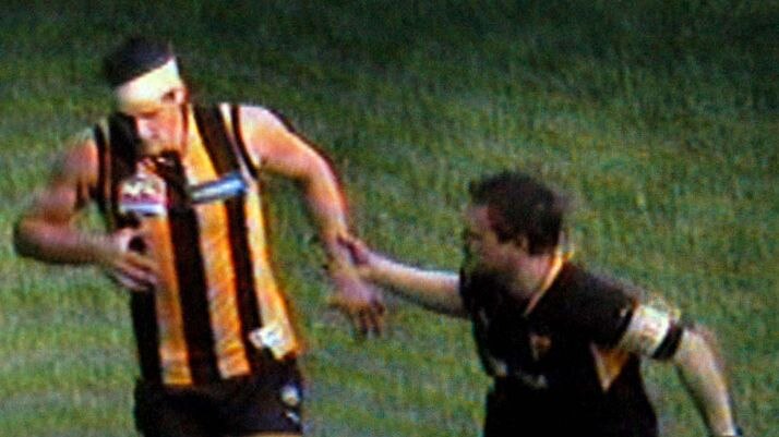 Hawthorn's Trent Croad hobbles off the field with a broken foot.