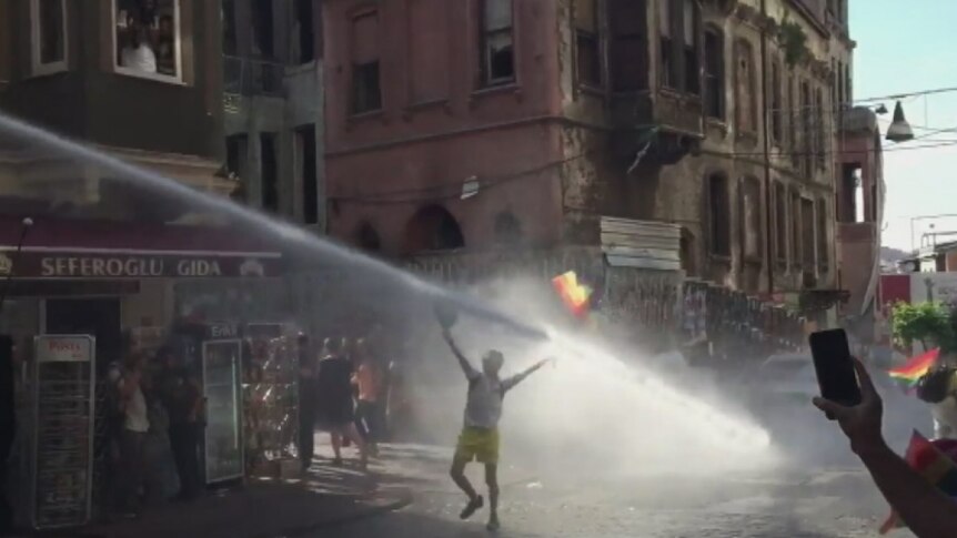 Turkish police blast a protester with a water cannon