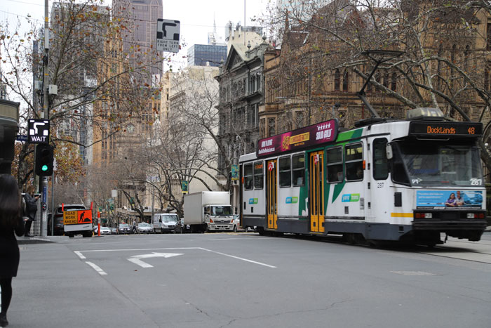 A hook turn bay on a Melbourne street with a tram going past.