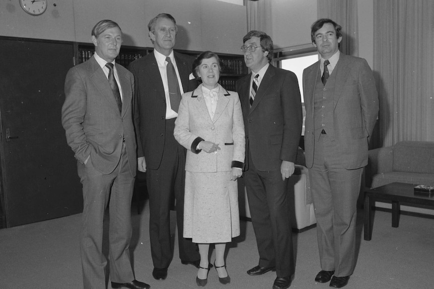 A black and white photo of a group of five people.