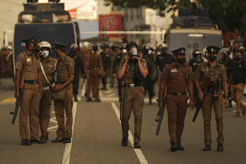 Sri Lankan police officers secure an area during a protest demanding resignation of the government in Colombo, Sri Lanka.