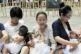 Six women breastfeed their babies at a demonstration in China.