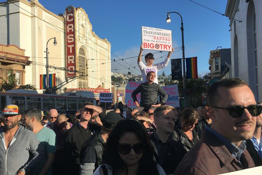 Protesters gather in San Francisco's Castro District. One holds a sign that says 'bigotry' is the only reason for the ban.