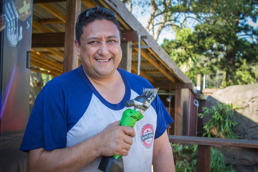 Man holding sheep clippers.