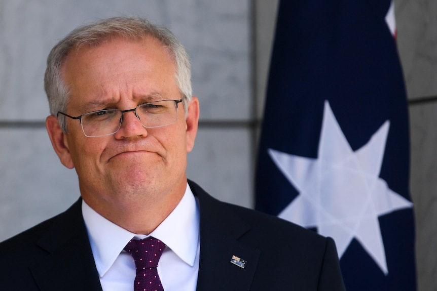 A medium close up shot of the Prime Minister speaking during a press conference