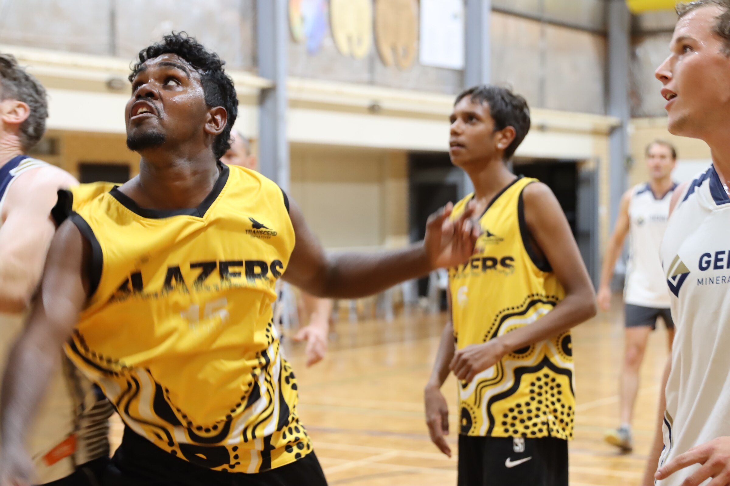 Basketball players on court.