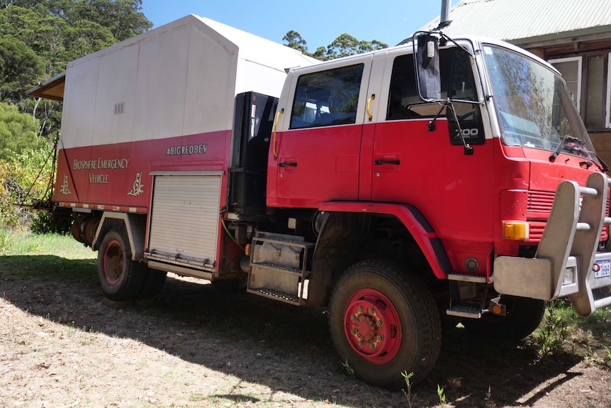 A large red truck with the words Big Red Bev written on it