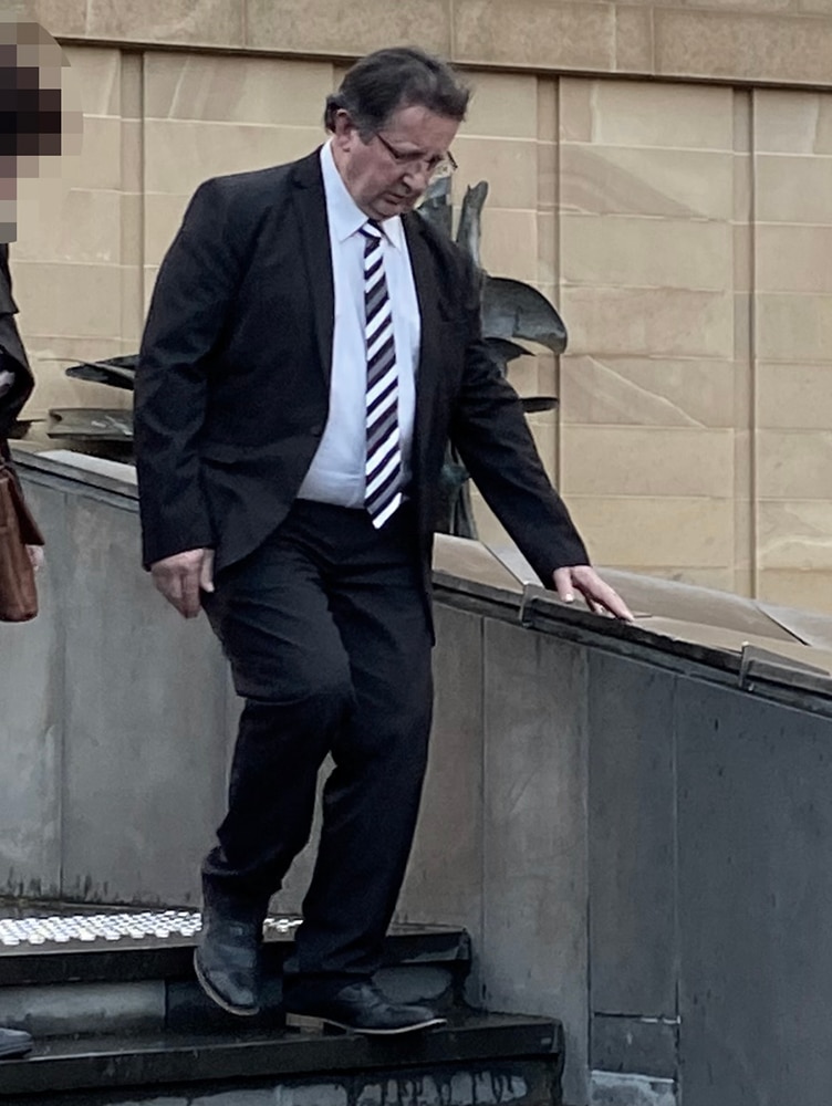 Sean Peter Burk walks down steps in Hobart.