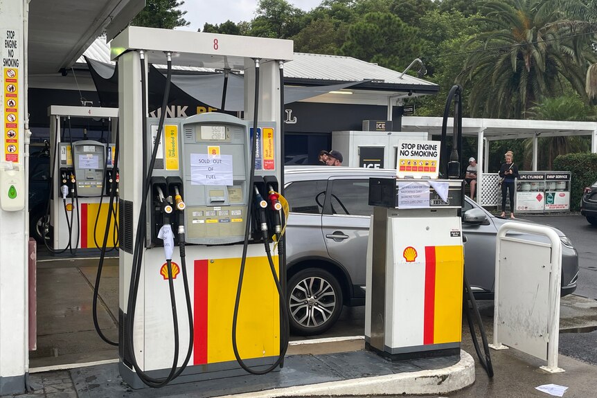A petrol pump with a fuel shortage sign.