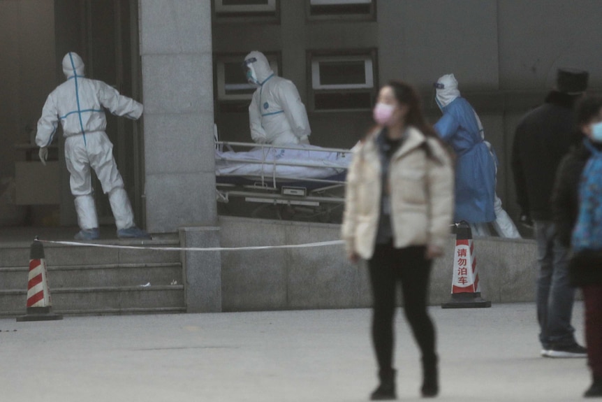 Medical staff transfer a patient at the Jinyintan hospital.