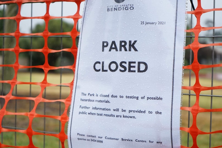 Printed sign on fence reading park closed.