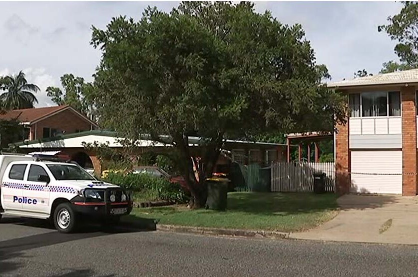 Police car and tape at a house in Rockhampton where a 53-year-old woman was found dead.
