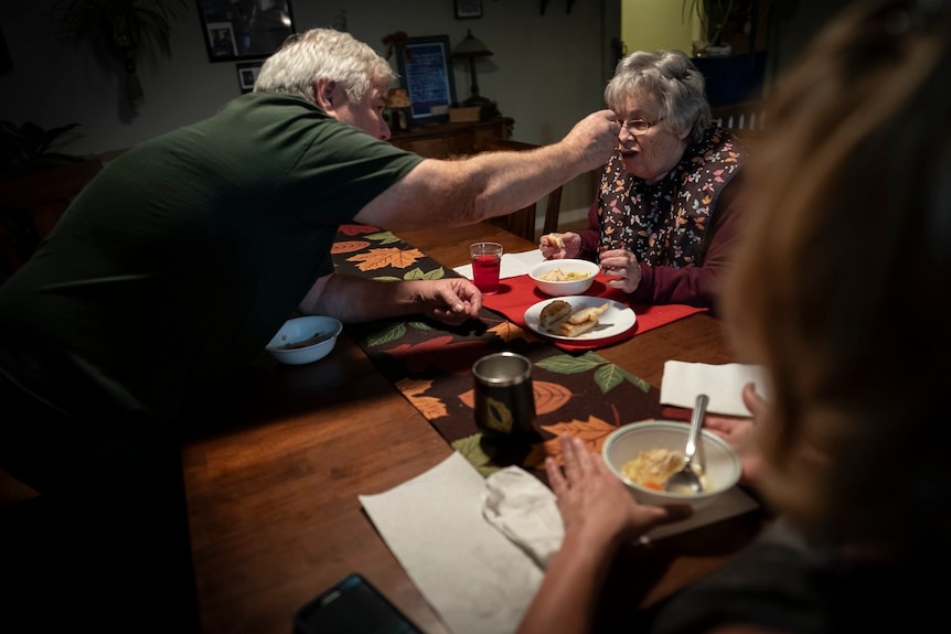 Jimmy Ryder feeds his mother-in-law, Betty Bednarowski, during dinner.