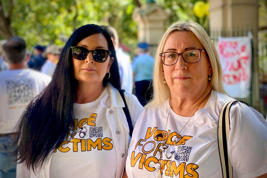 Michelle Liddle and Judy Lindsay wear shirts that read 'voice for victims'