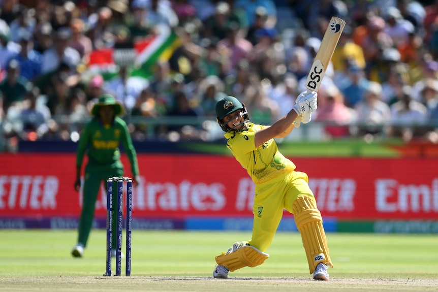 Australia batter Ashleigh Gardner completes a stroke through the off side in the T20 World Cup final.