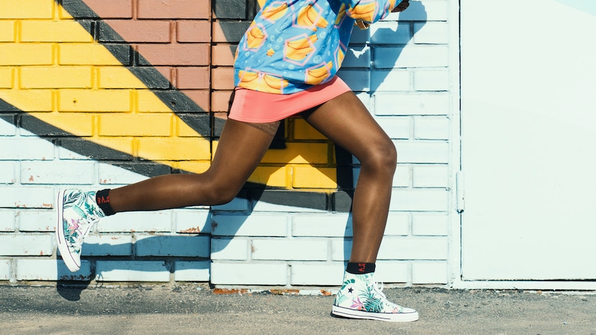 A woman running against a bright background in a story about how running helps people get through the pandemic.