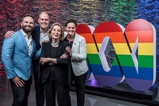 Four people next to a pride-coloured ABC logo.