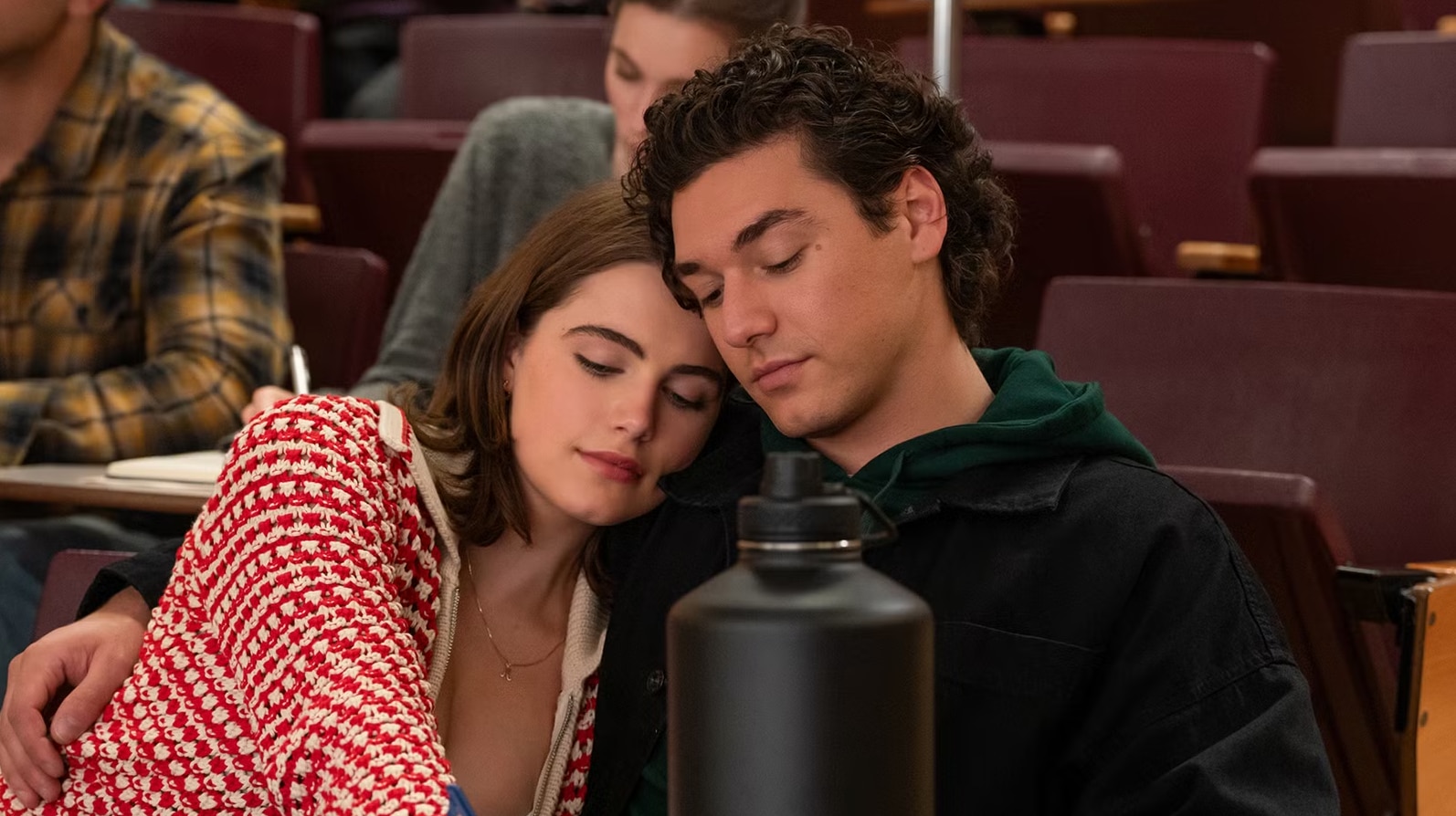 Ella Bright and Belmont Cameli intimately close in a lecture theatre in a scene from Off Campus.