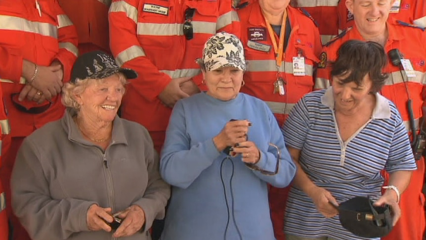 An 82yo woman and two others aged in their 60s and 70s with SES officers after being found safe.