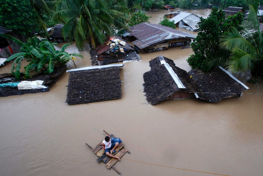 Super typhoon victims flee again as rains flood Philippines.