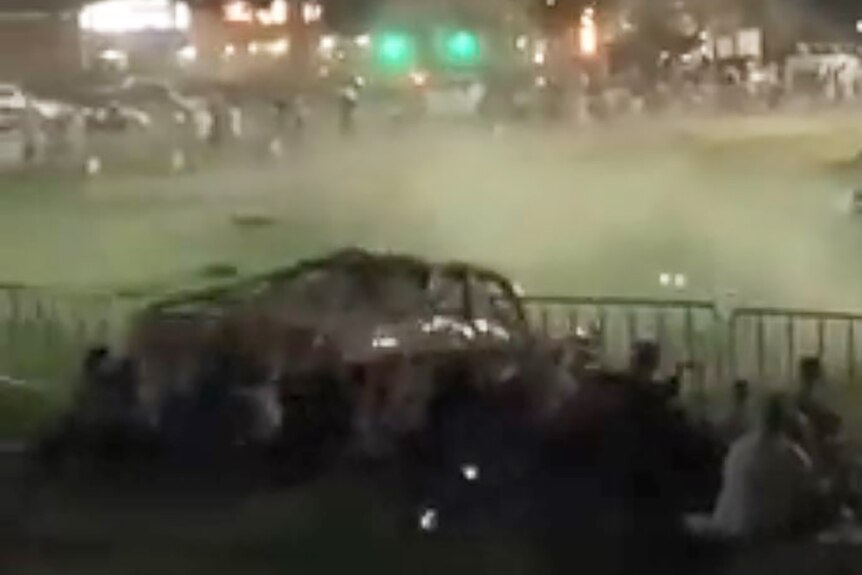 Rally car crashing through barrier into crowd
