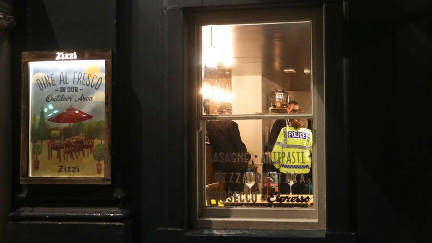 Police inside a restaurant believed to have been visited by Sergei Skripal on Sunday.