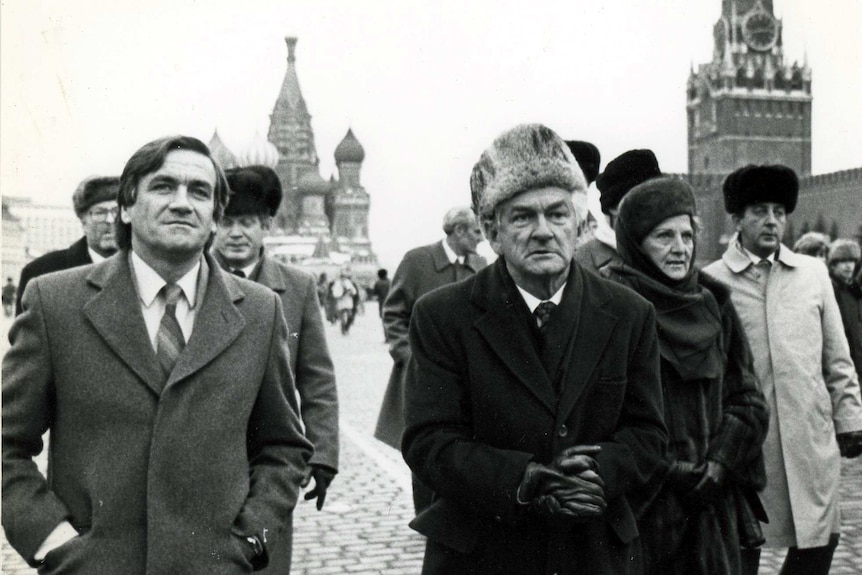 Hawke and wife Hazel in fur hats walking with Cassidy beside him.