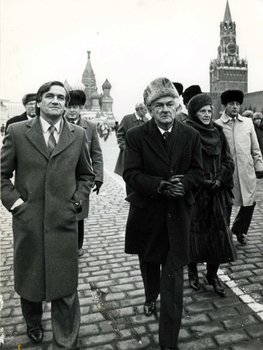 Hawke and wife Hazel in fur hats walking with Cassidy beside him.