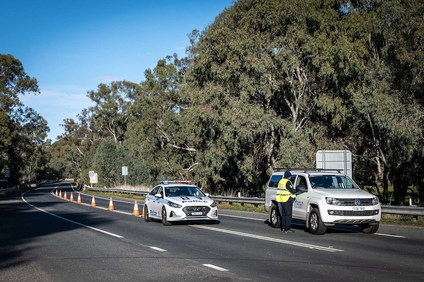 Police stop a lone car at the Howlong border crossing.