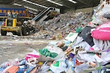 A pile of rubbish next to a trackor