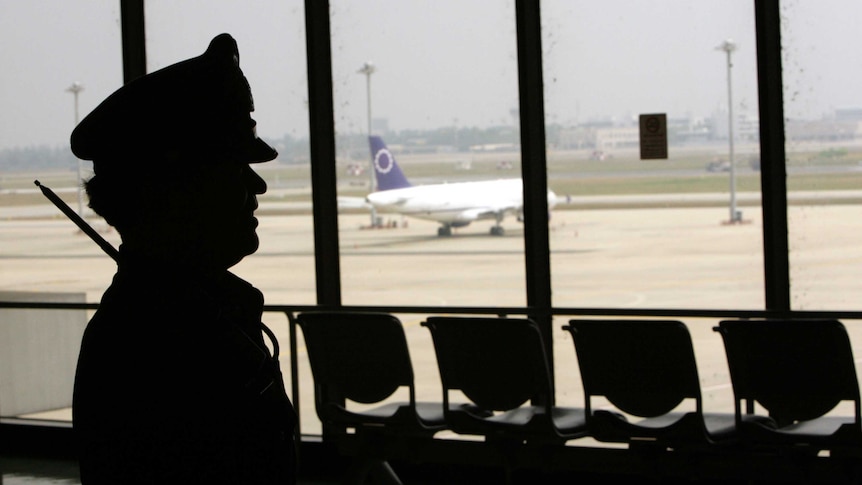 A security official stands in a terminal of Bangkok's Don Muang airport