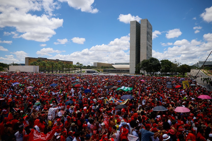 Thousands of supporters in red gather outside Planalto Palace ahead of Lula's swearing in ceremony.