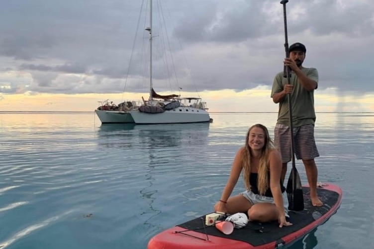 A man and woman on a paddle board