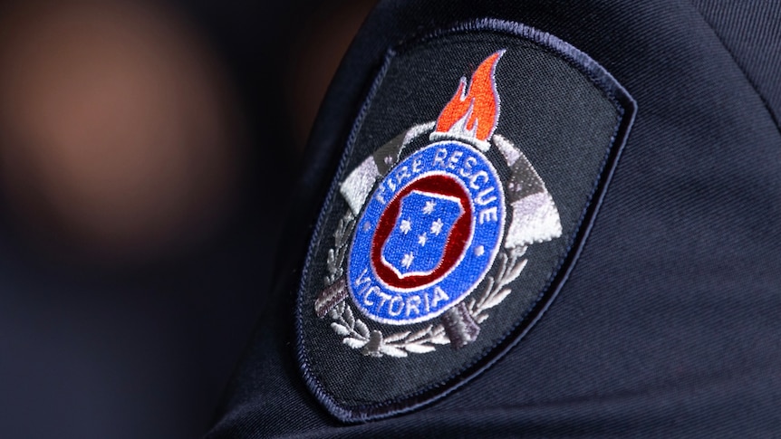 A close up shot of a Fire Rescue Victoria uniform badge on a person's shoulder