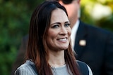 A woman with brunette hair smiles