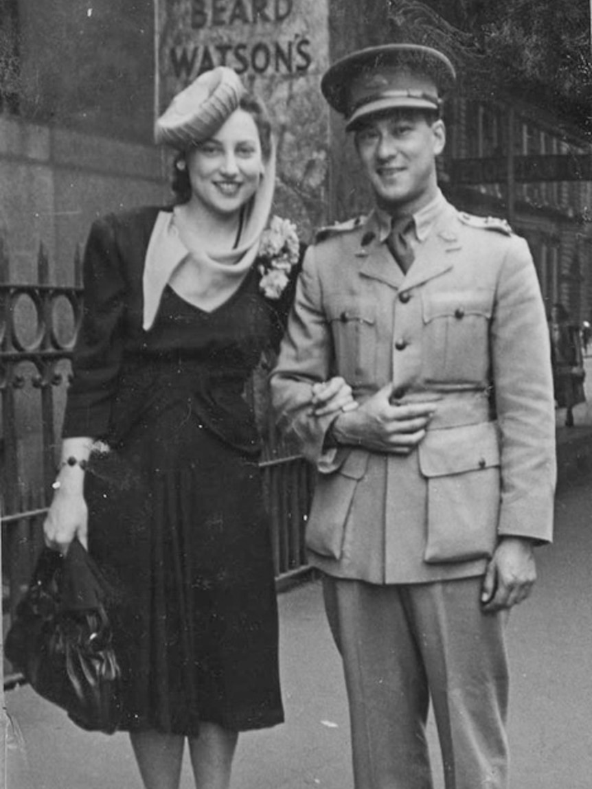 Black and white photograph of woman with and a man dressed in military uniform.