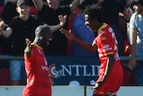 Bruce Djite and Bruce Kamau celebrate a goal against Brisbane Roar