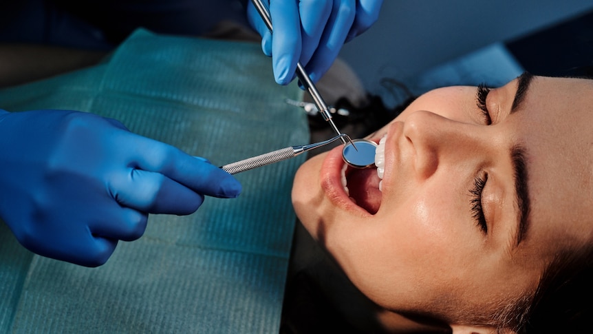 A woman receiving dental treatment.